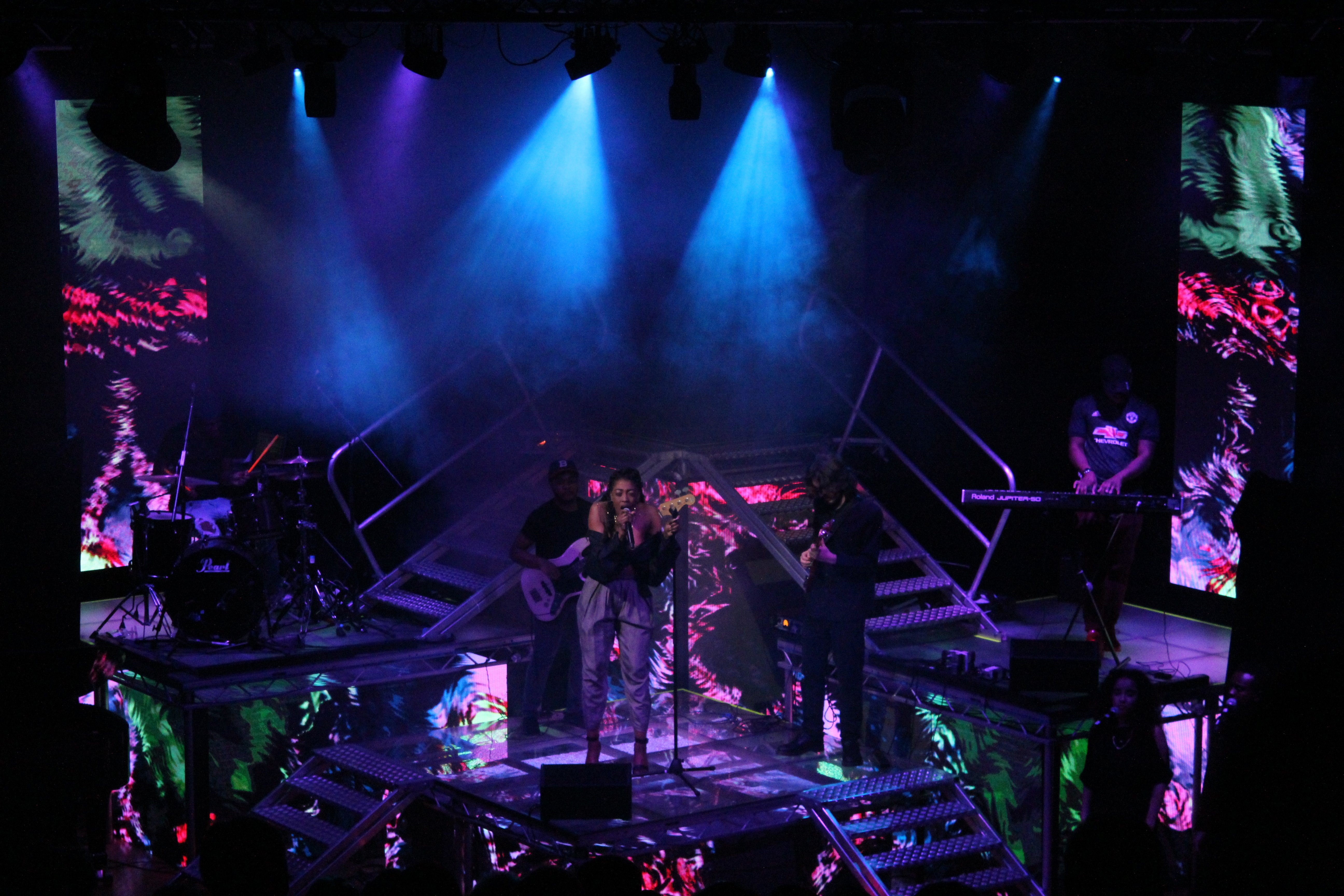 Band and Singer on a multi level stage with video backdrop and floor